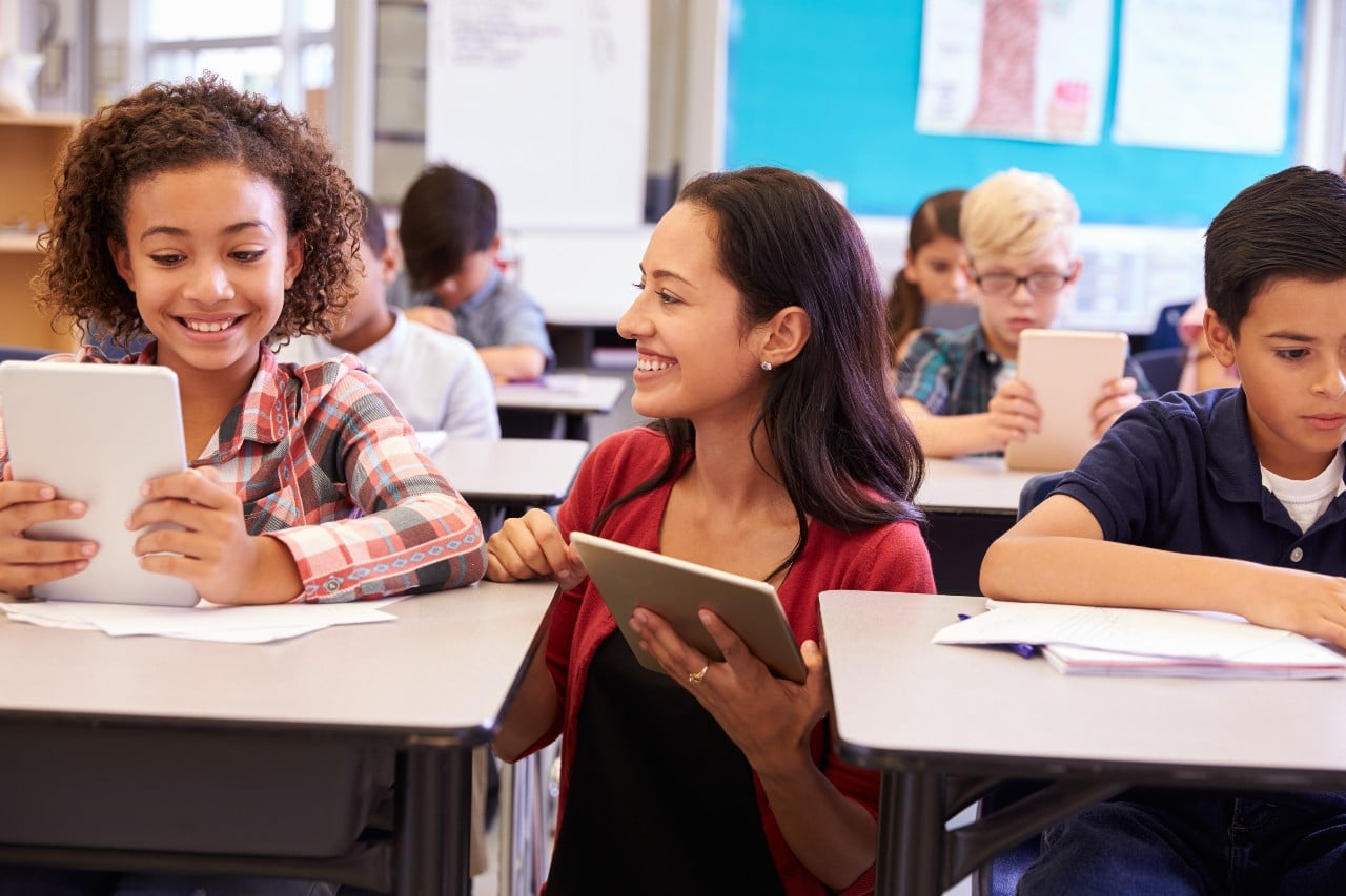 Teacher helps student with computer